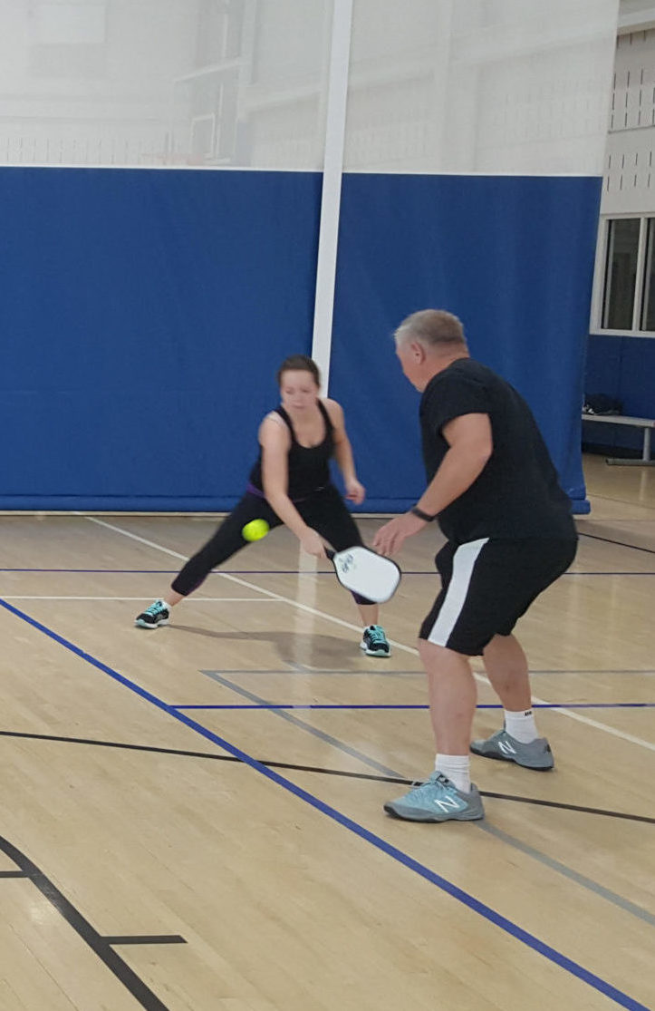 Adults playing pickleball