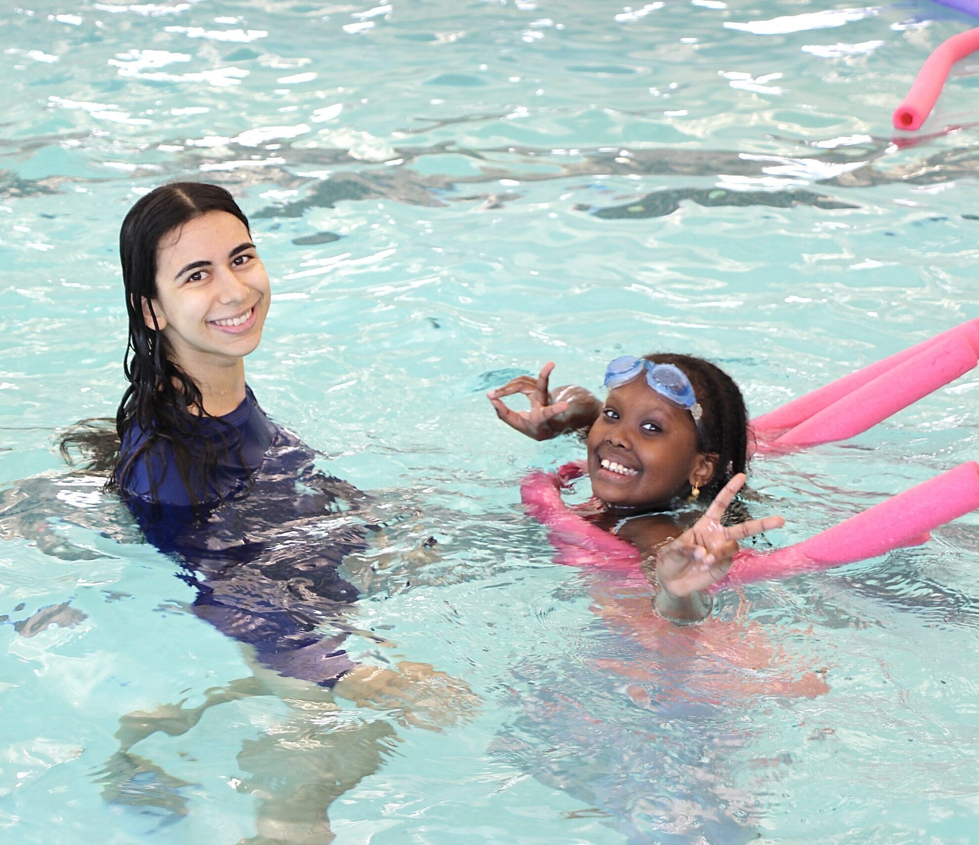 GBYMCA swim instructor and student having fun in the program pool during Camp Splash